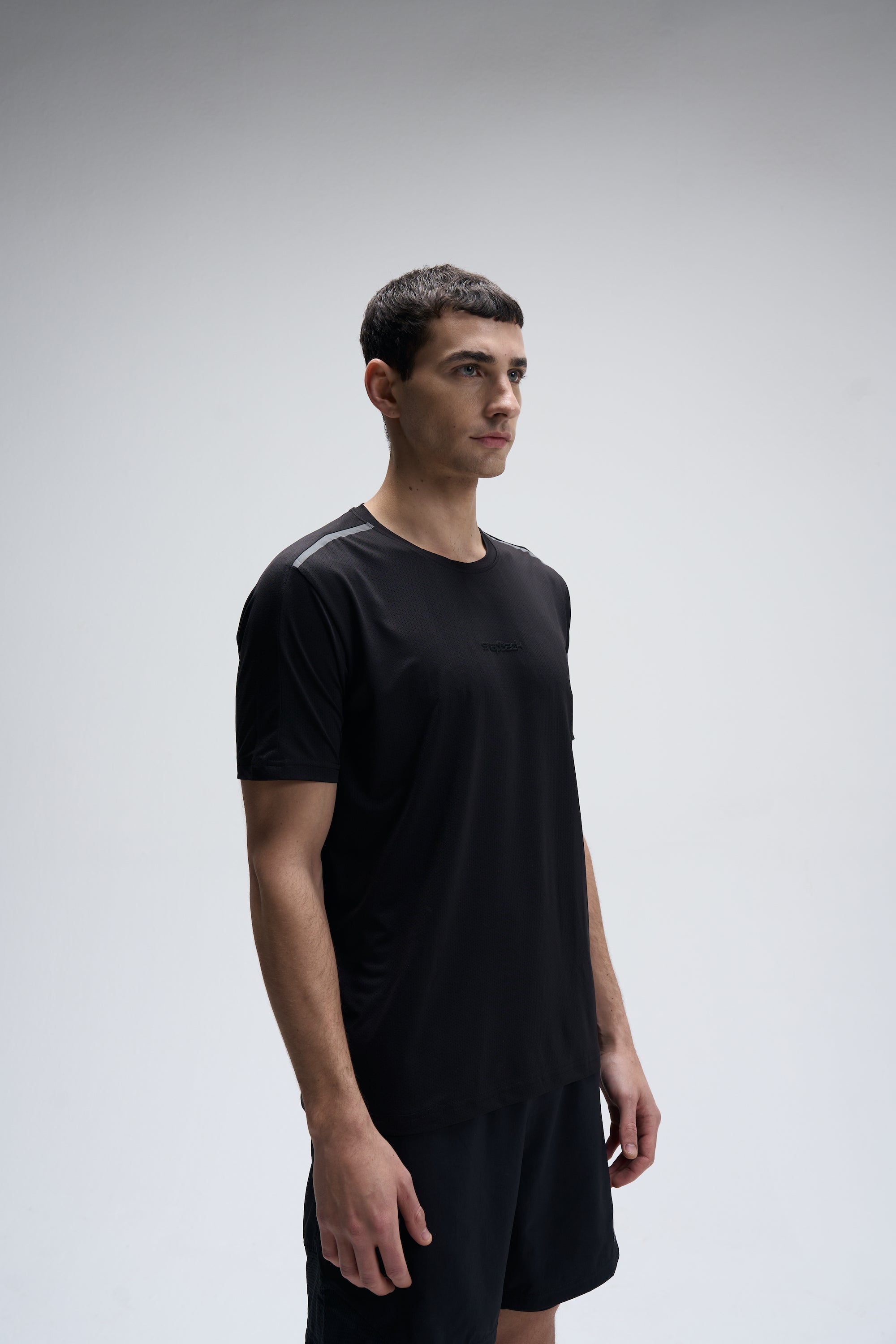Men’s black regular fit Supima cotton T-shirt with short sleeves and crew neck worn by male model.