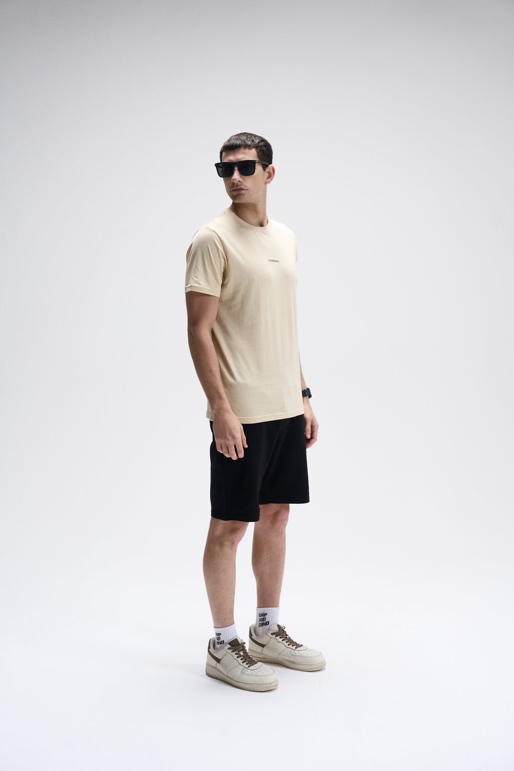 Men’s SoftLuxe Crew T-shirt in summer sand with regular fit, paired with black shorts and beige sneakers.