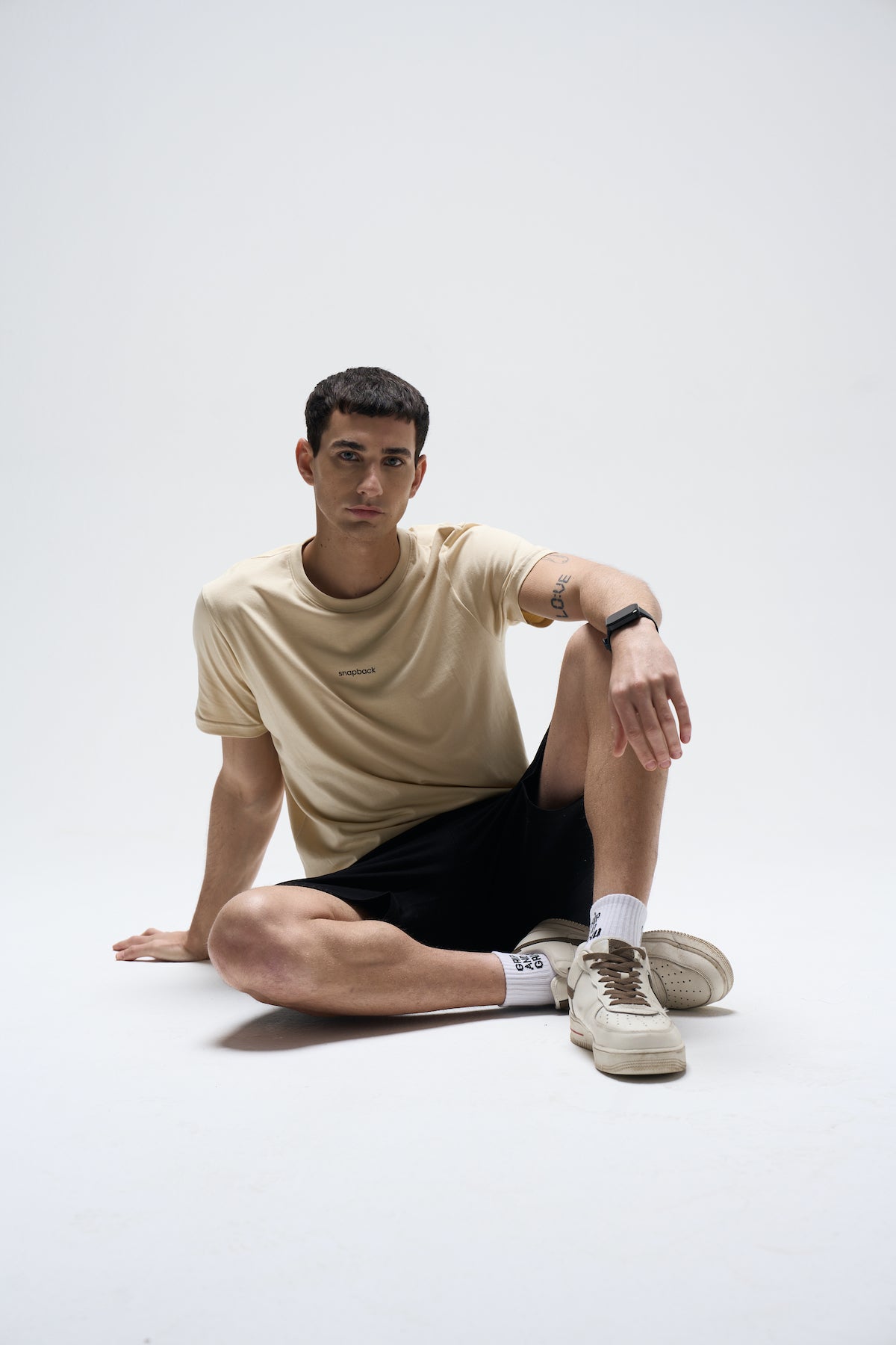 Men’s Summer Sand Supima cotton T-shirt with regular fit, paired with black shorts and beige sneakers.